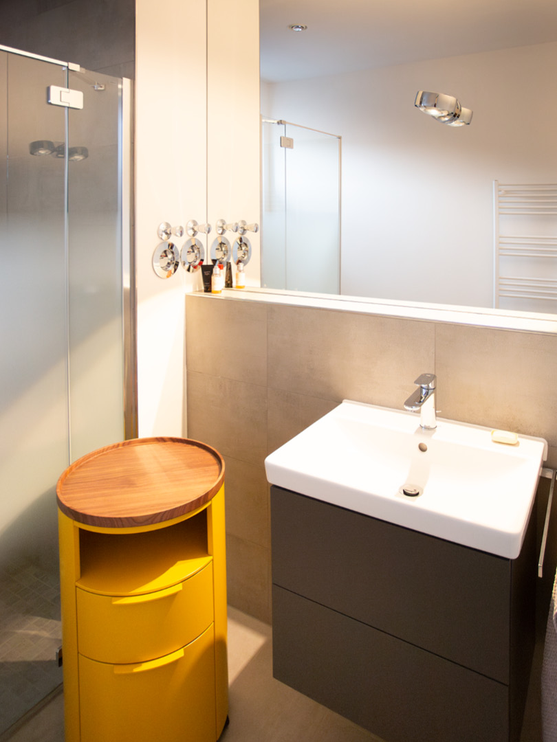 Luxuriöses Badezimmer mit hochwertigen Materialien und maßgefertigten Einbauten in neutralen Designtönen